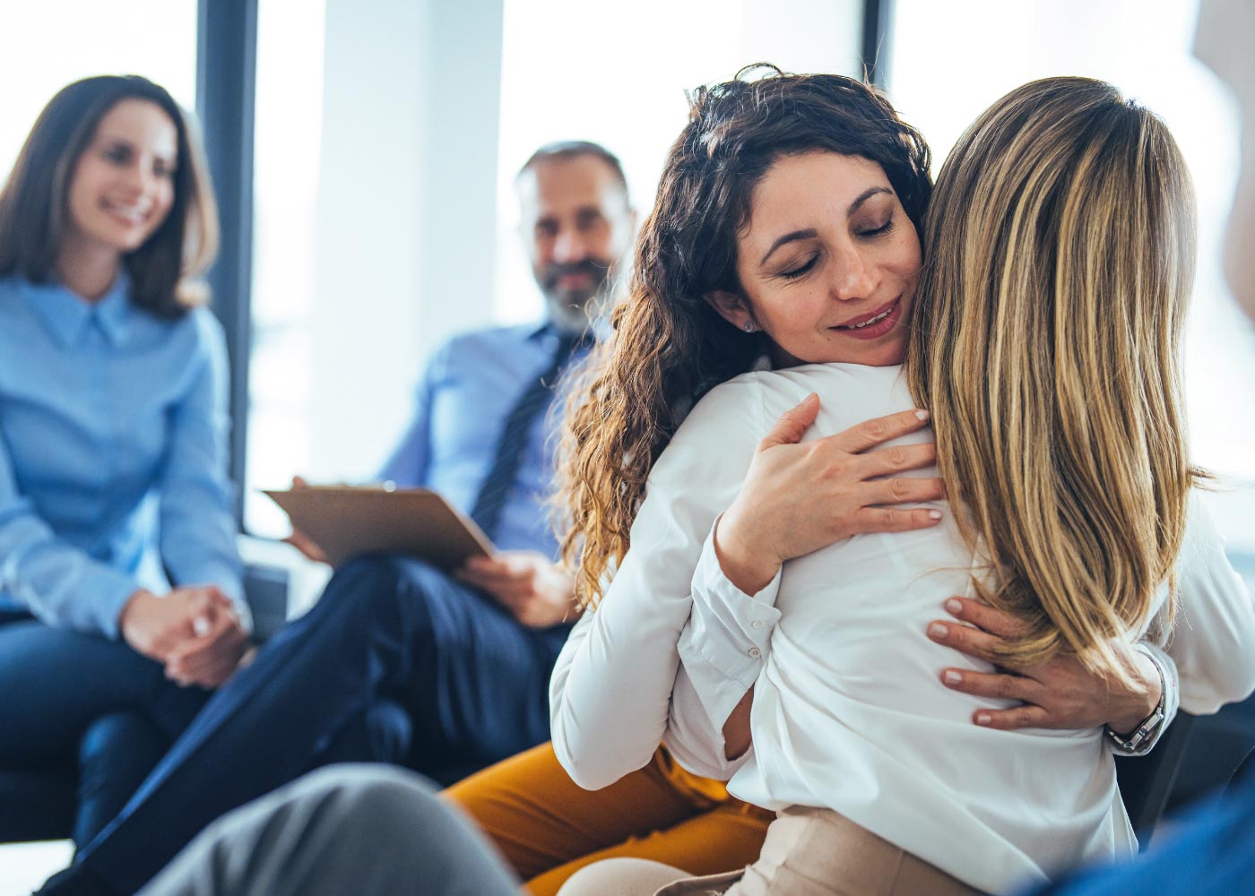 a female client during an intervention together with the dedicated staff from addiction treatment center