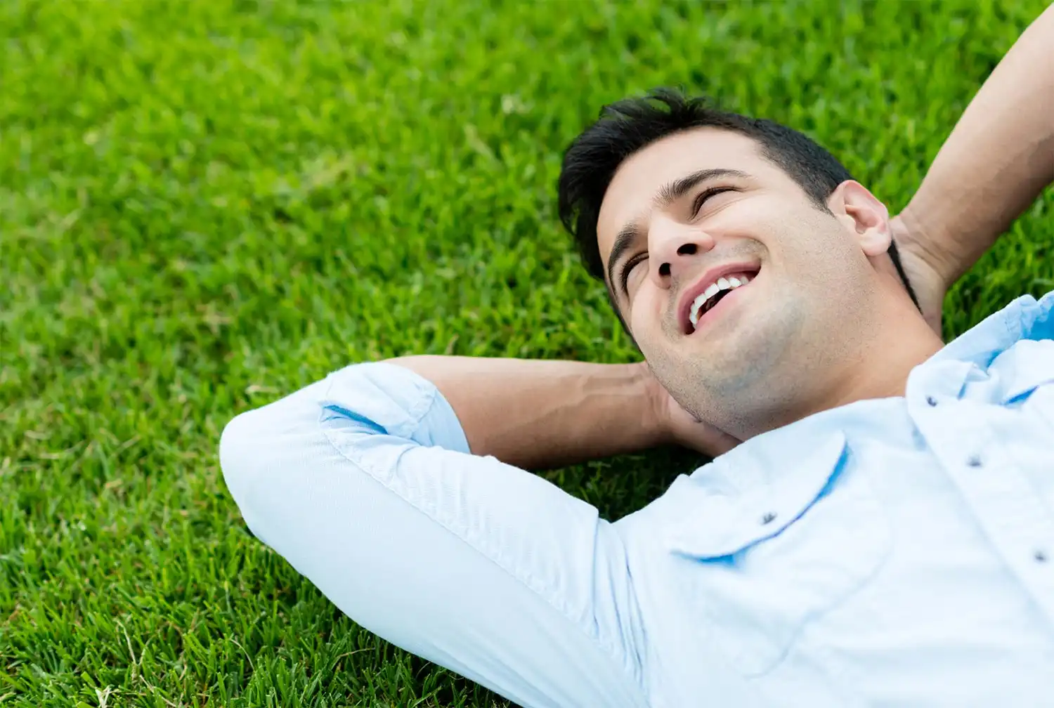 a happy male client lying on the grass at Drug and Alcohol Rehab in Menifee and Temecula, CA.