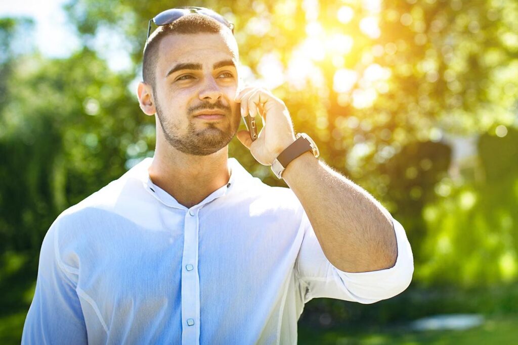 man wearing white polo calling at a rehab center in menifee california to get help