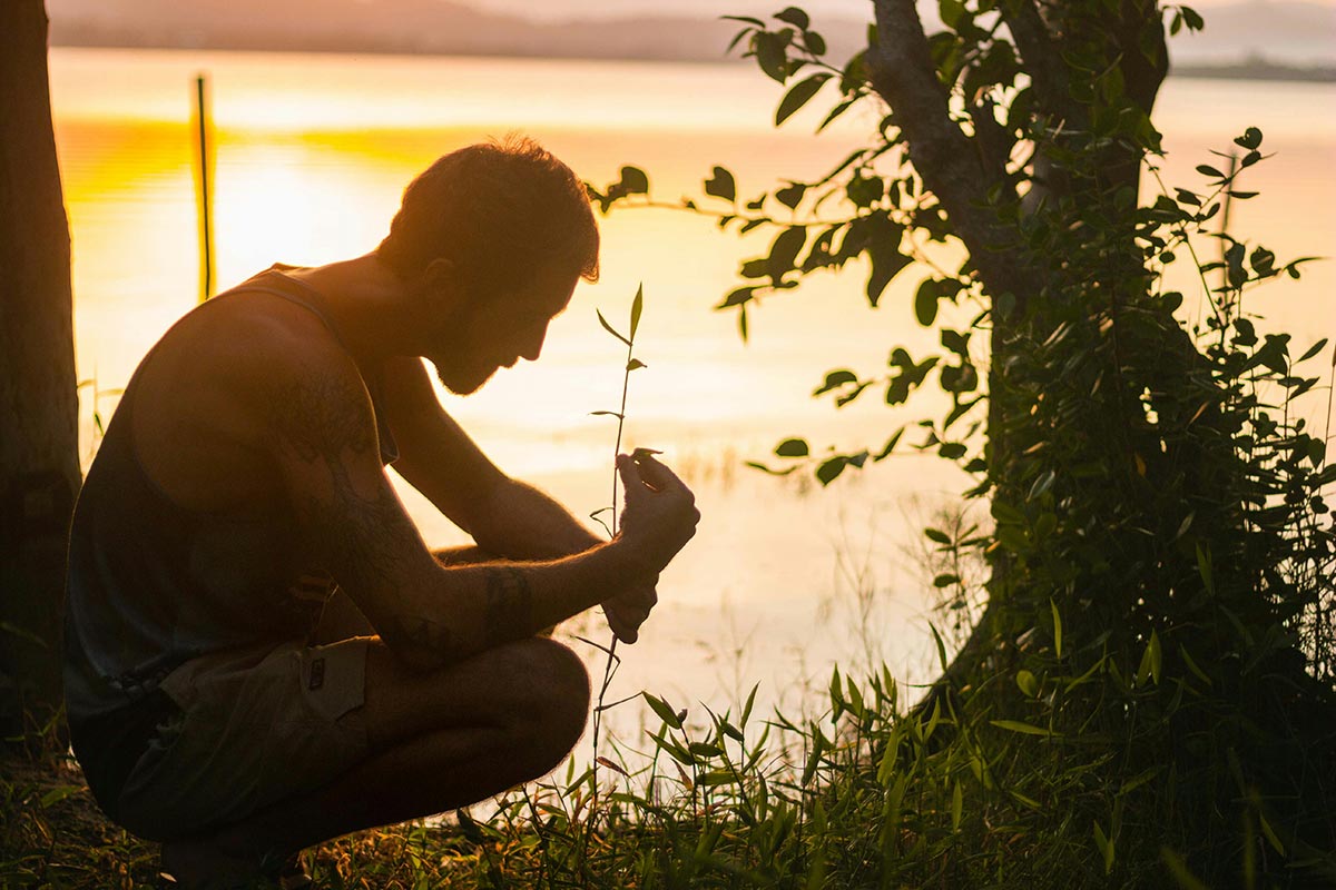 a man struggling with substance abuse sitting near the ocean thinking about recovery