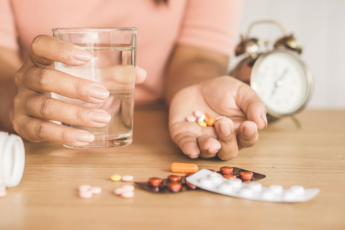 different kinds of pills on a woman's palm