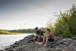 dad and his teen son during fishing activity