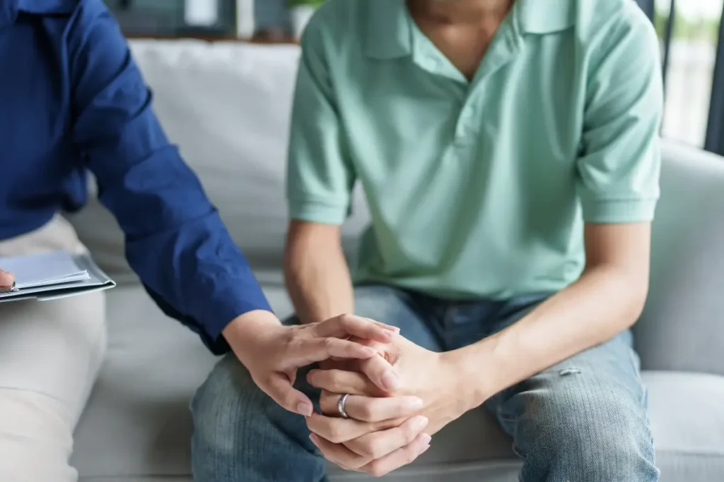 a male client during one on one counseling teaching him coping skills in addiction recovery
