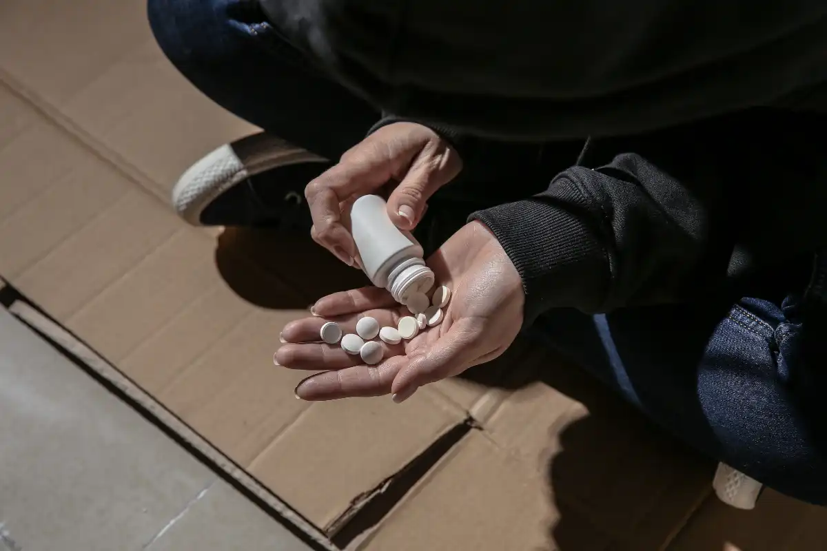 a man wearing black hoodie taking more medication than prescribed