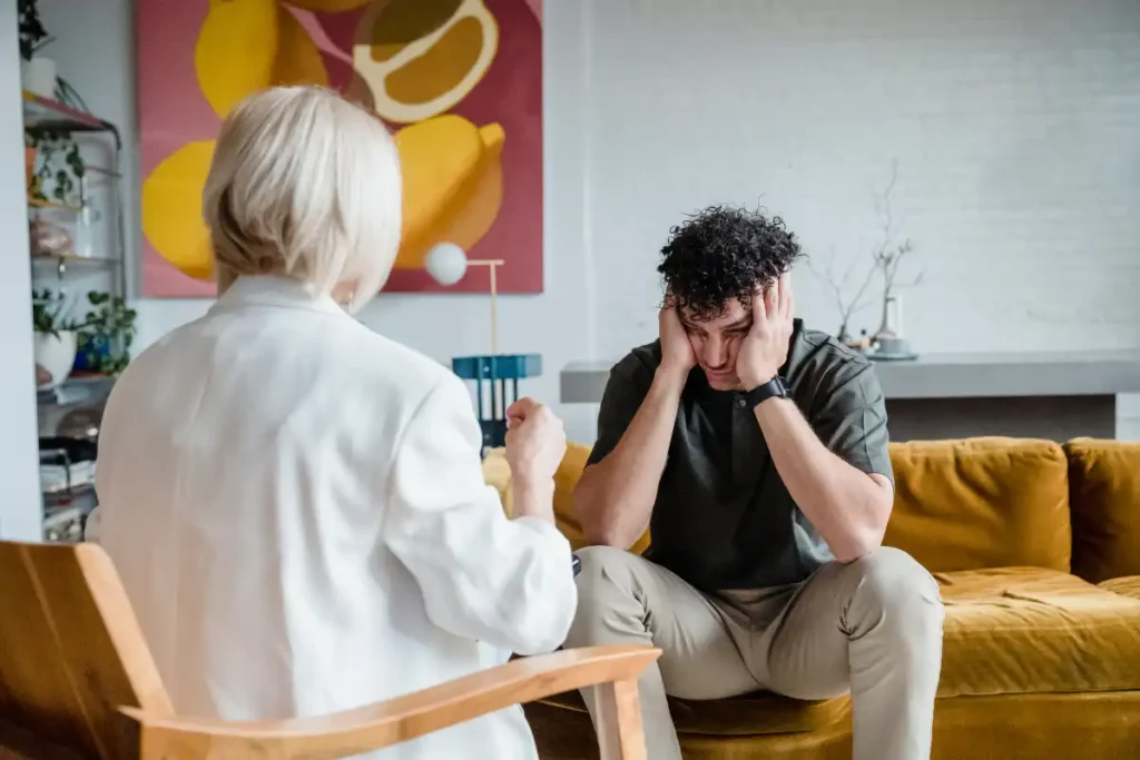 photo of a psychotherapist and a young man suffering from anxiety in drug and alcohol rehab in menifee CA