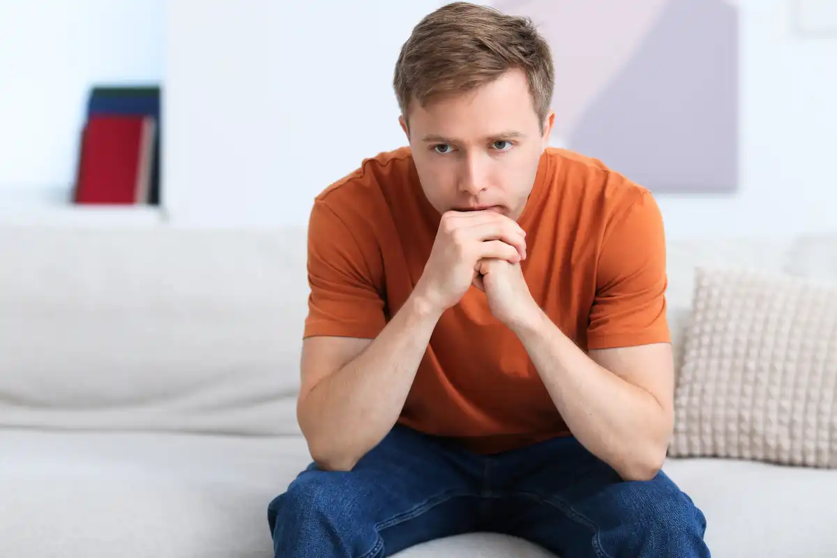 Sad Thoughtful Man on Sofa at Home