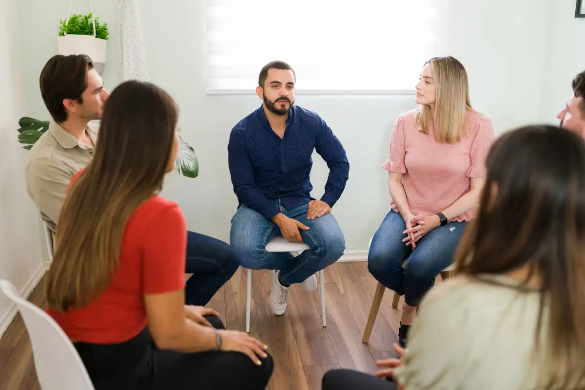 men and women in group therapy