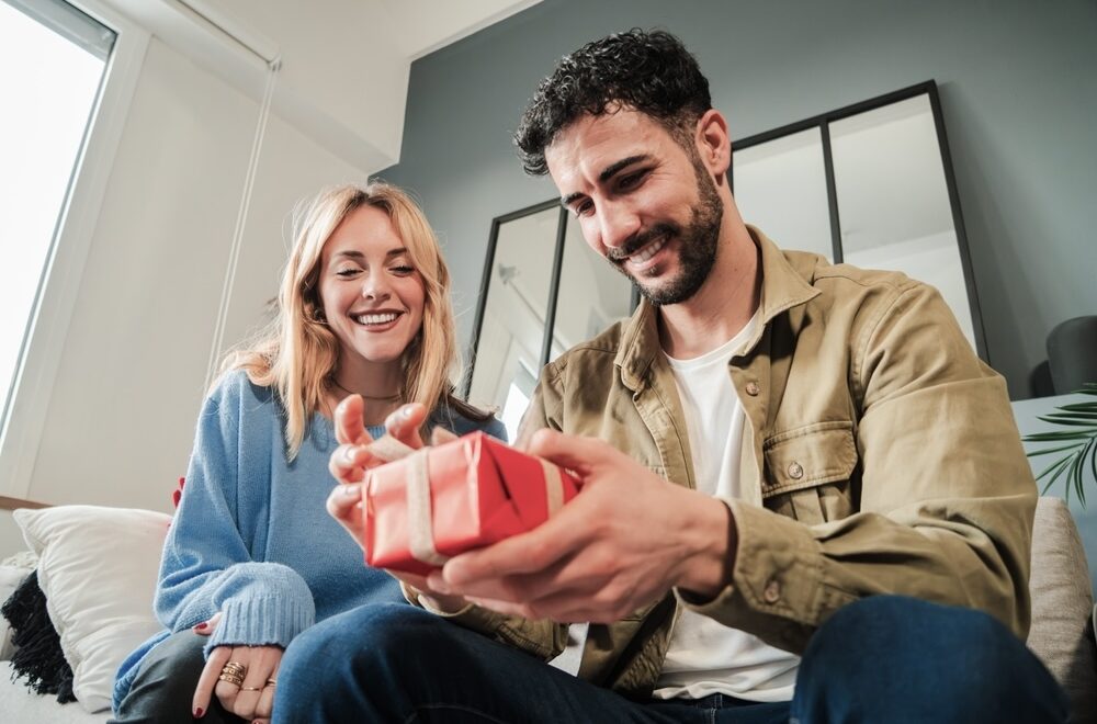 Female giving her partner a sobriety gift on his sober anniversary