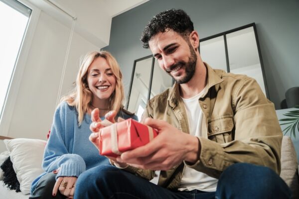 Female giving her partner a sobriety gift on his sober anniversary