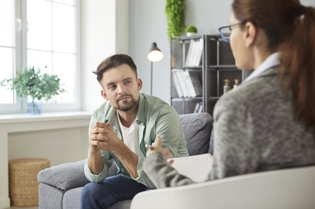 Adult male talking to an addiction specialist in a drug rehab in Menifee CA