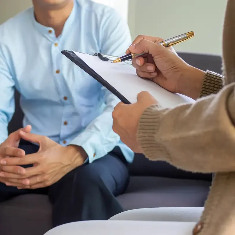Therapist Recording Patient's Symptoms upon Consultation